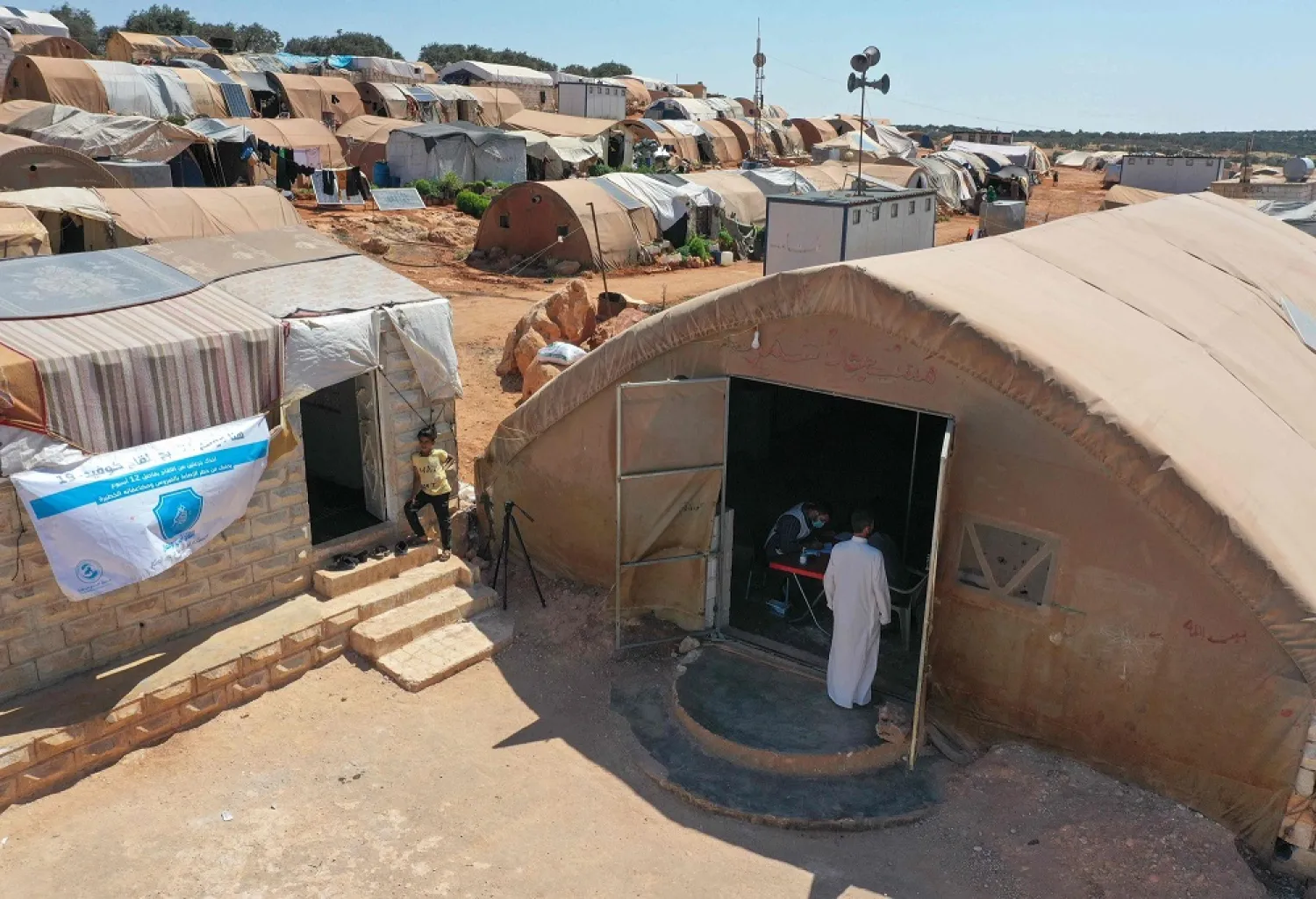 People enter a tent turned into a vaccination center at a camp for the internally displaced near Marret Misrin town, in northwestern Syria's Idlib, Syria, June 14, 2021. (AFP)