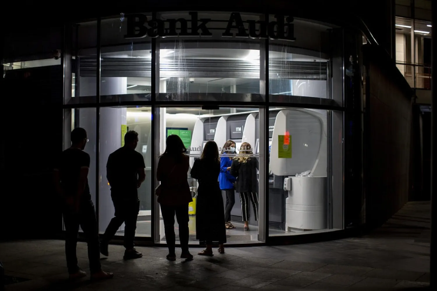 People wait to use ATM machines outside a closed bank in Beirut, Lebanon. (AP)