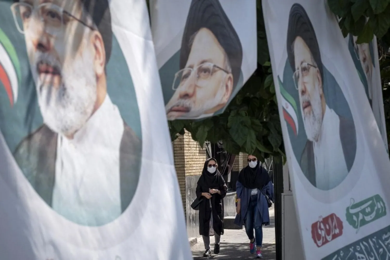 Posters of Iranian presidential candidate Ebrahim Raisi are seen in Tehran on June 14, 2021. (AFP)