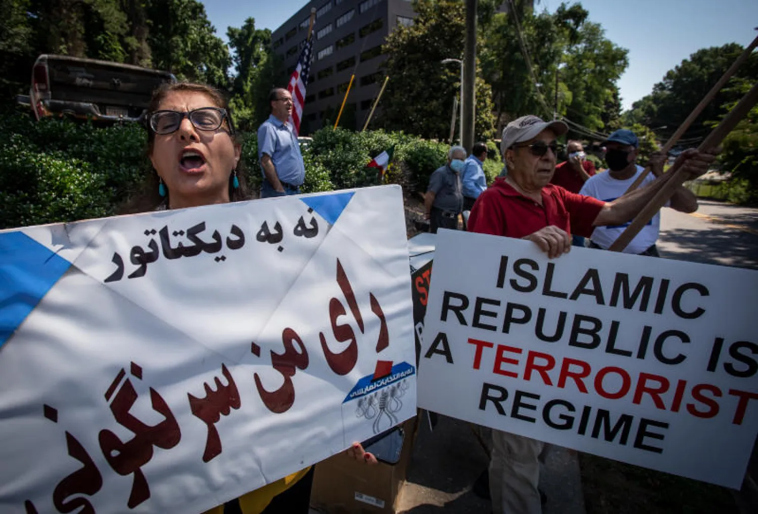 محتجون أمام مركز يدلي فيه الأميركيون الإيرانيون في ولاية جورجيا بأصواتهم في الانتخابات الرئاسية الإيرانية (أ.ب)