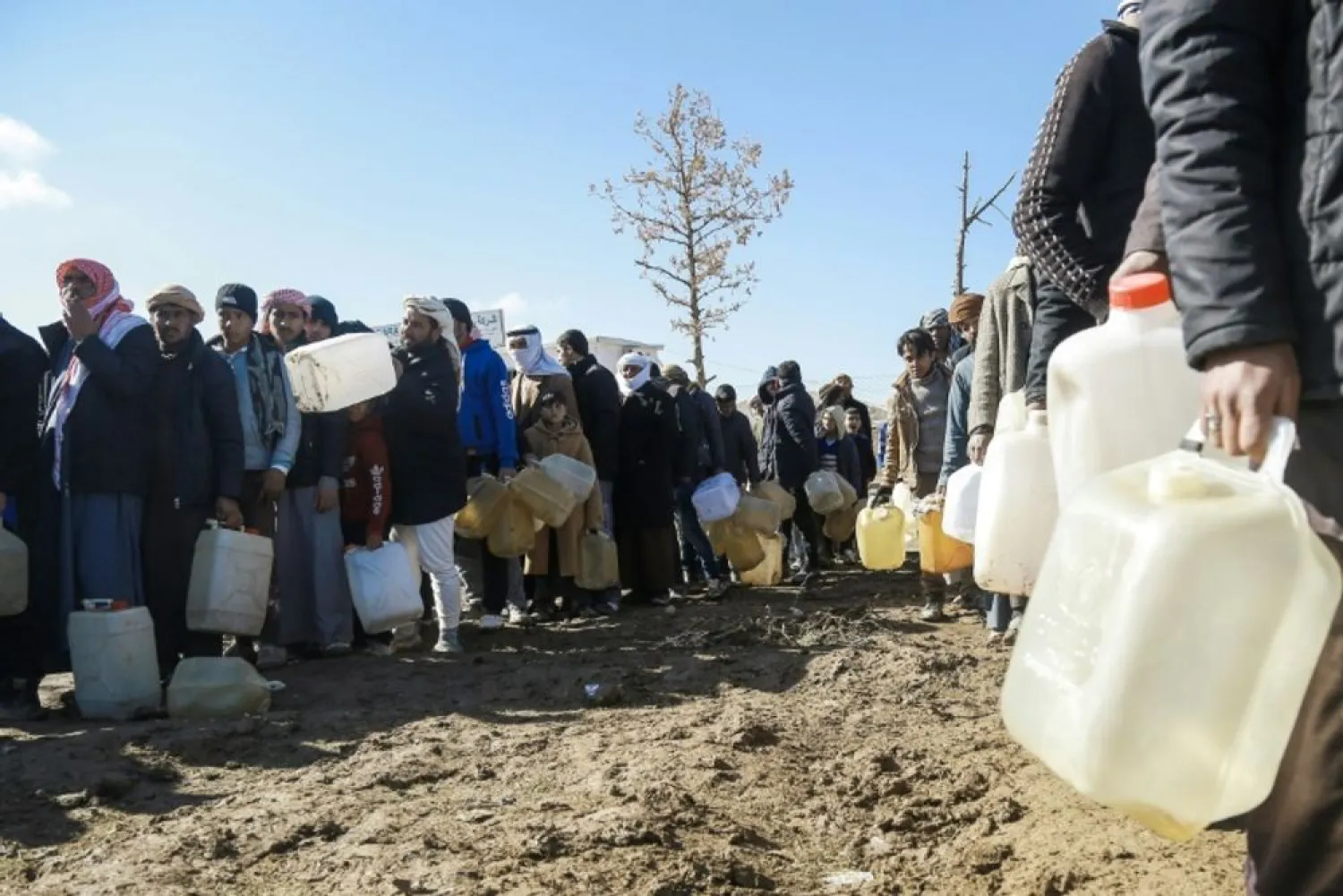 Delil SOULEIMAN (AFP/File) Refugees who fled the Iraqi city of Mosul queue for heating fuel at the UN-run al-Hol refugee camp in Syria's Hasakeh province, on January 29, 2017