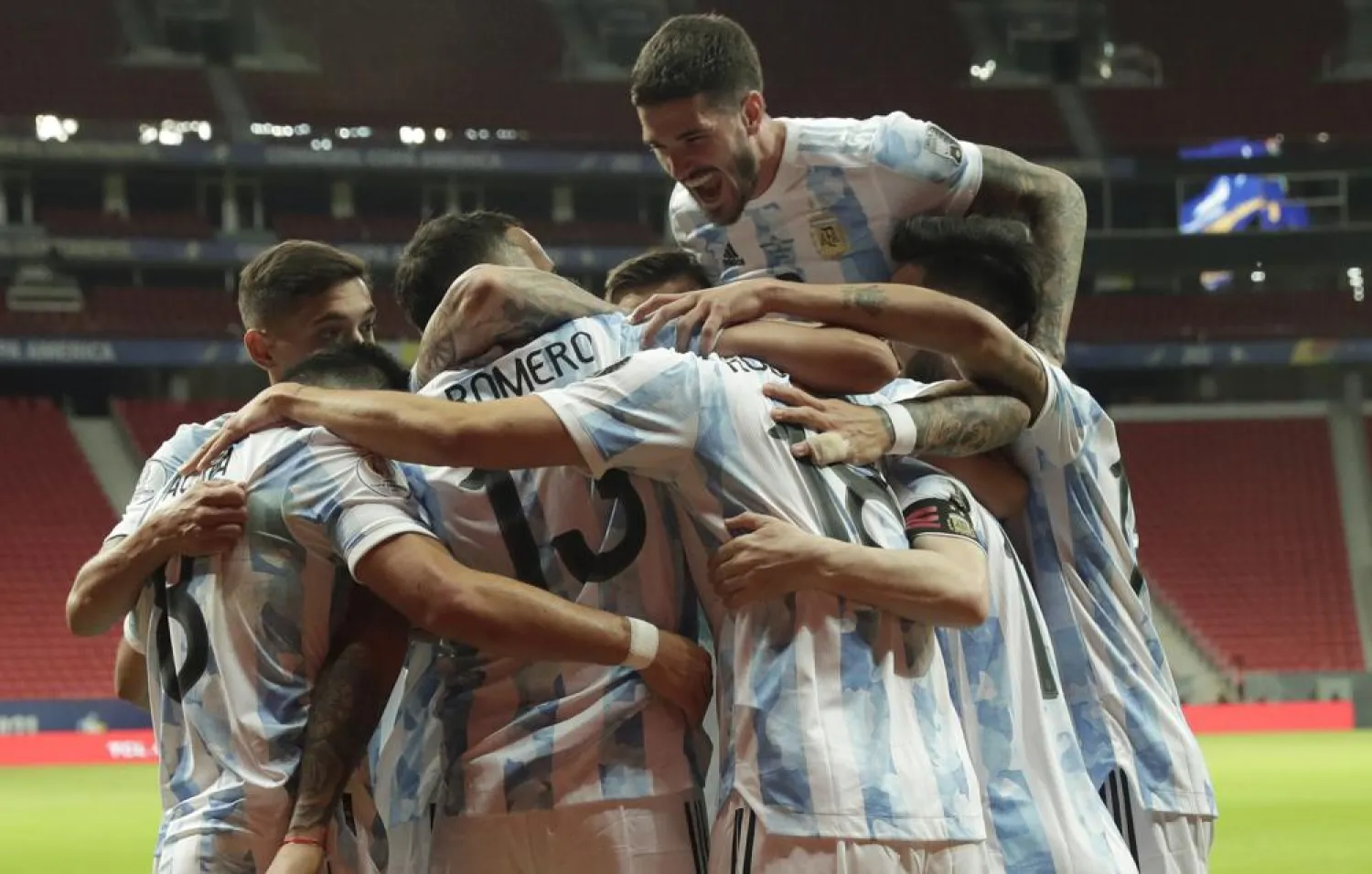 Players of Argentina celebrate their side's opening goal against Uruguay scored by teammate Guido Rodriguez during a Copa America match at the National Stadium in Brasilia Brazil, June 18, 2021. (AP)