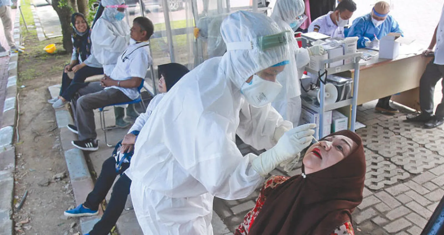 فحص كورونا قبل التلقيح في إندونيسيا (أ.ب)