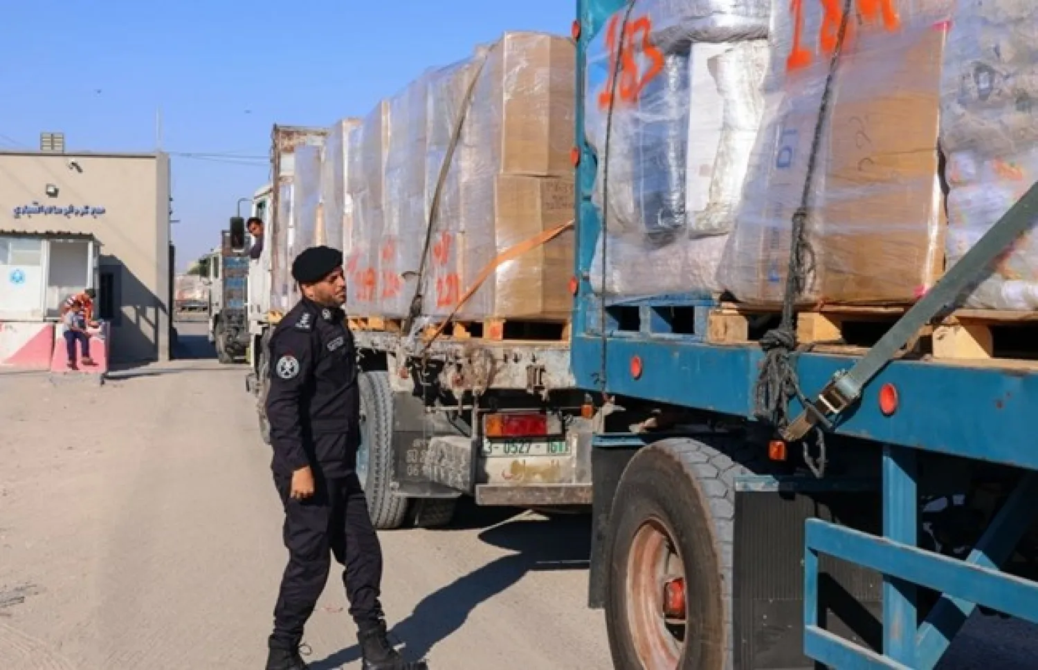A Palestinian police officer searches a truck's fabrics cargo slated for export at the Karm Abu Salem (Kerem Shalom) crossing in Rafah in the southern Gaza Strip, June 21, 2021. (AFP / SAID KHATIB) 0

