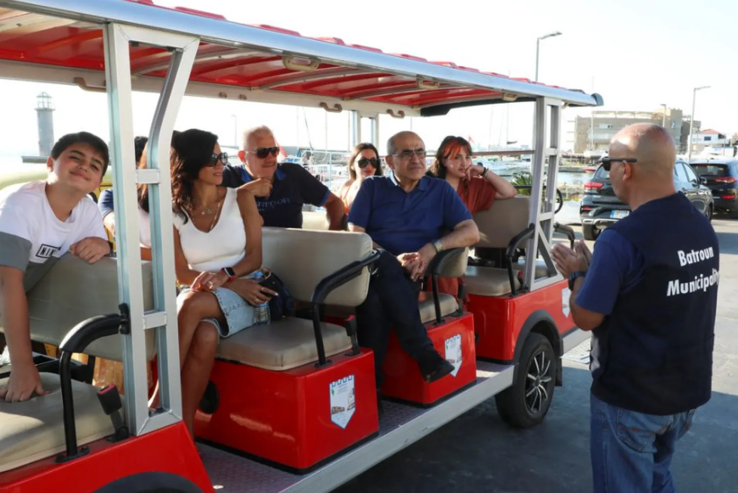 John Bechara, a 54-year-old tourist guide, talks to visitors as they sit on an electric vehicle in Batroun, Lebanon June 5, 2021. Picture taken June 5, 2021. REUTERS/Mohamed Azakir


