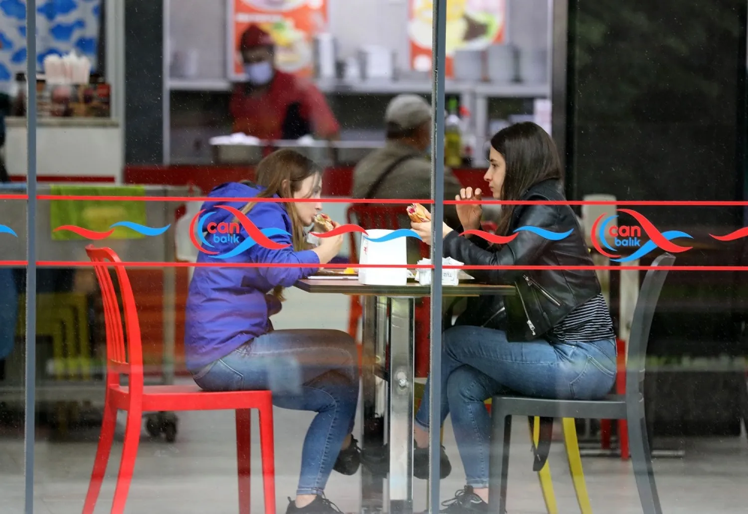 Customers eat at a reopened cafe in Ankara, Turkey, June 2, 2021. (AFP)