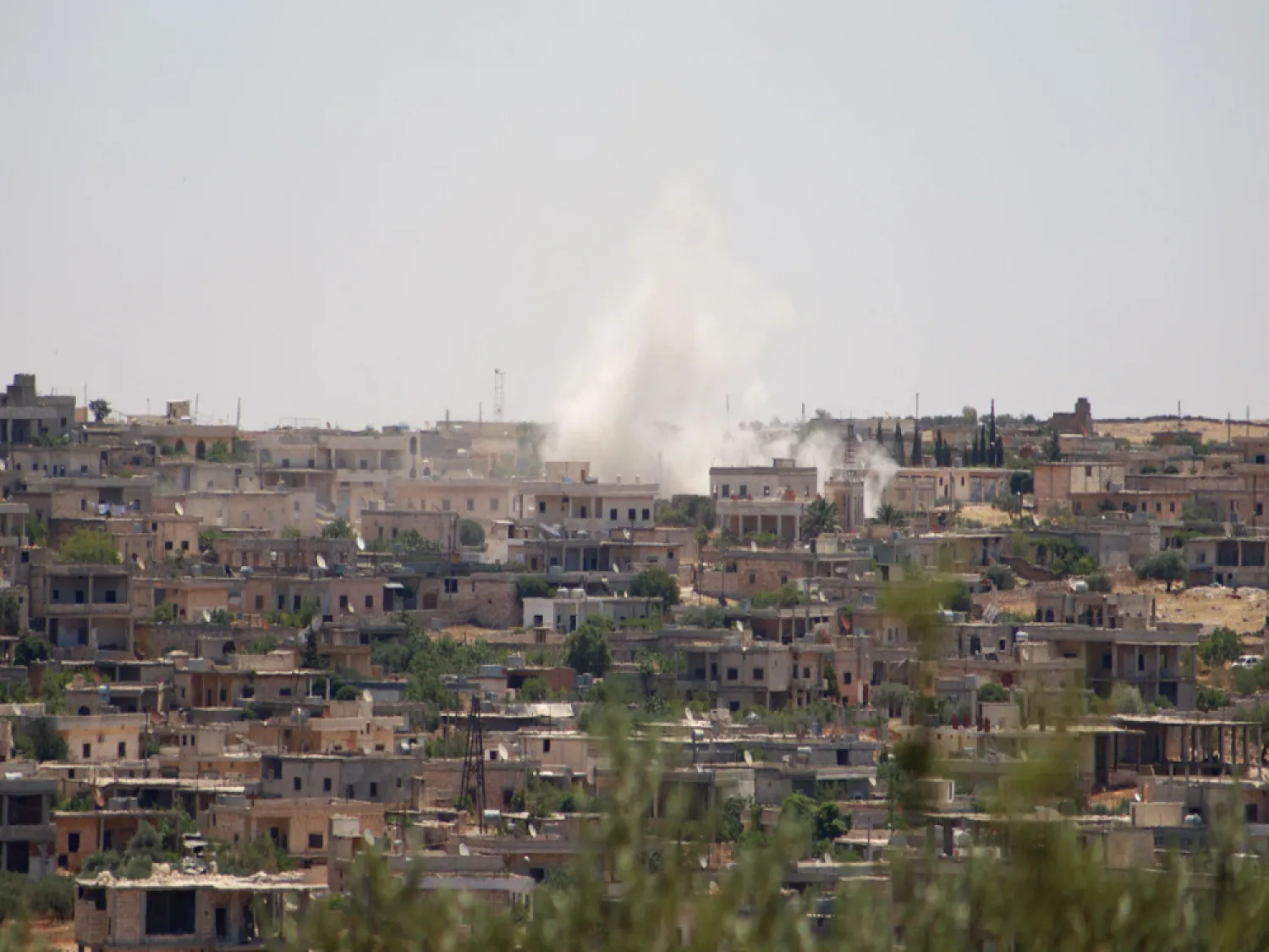 Smoke billows following reported bombardment by government forces in the Syrian northwestern town of Barah, in the Jabal al-Zawiya region. (AFP)