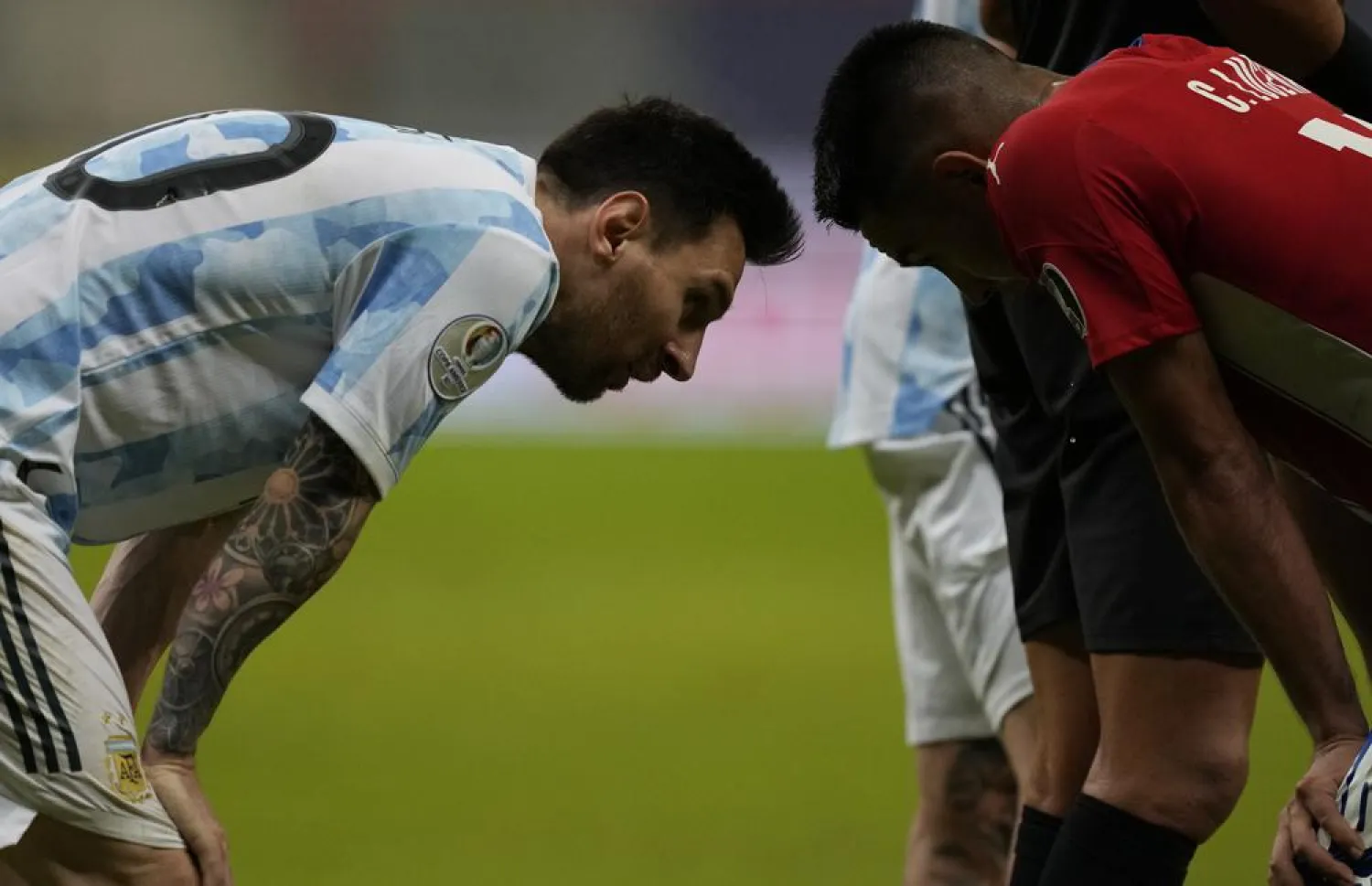Argentina's Lionel Messi, left, and Paraguay's Angel Cardozo talk at the end of a Copa America match at the National stadium in Brasilia, Brazil, Monday, June 21, 2021. (AP)