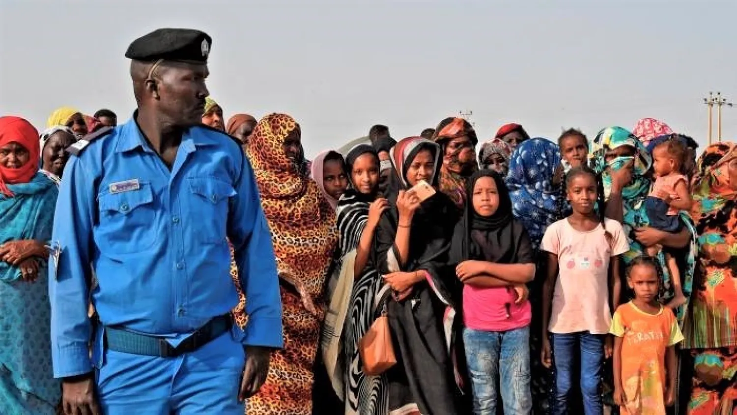 A policeman guards displaced people at a shelter camp north of Khartoum (AFP/Getty)

