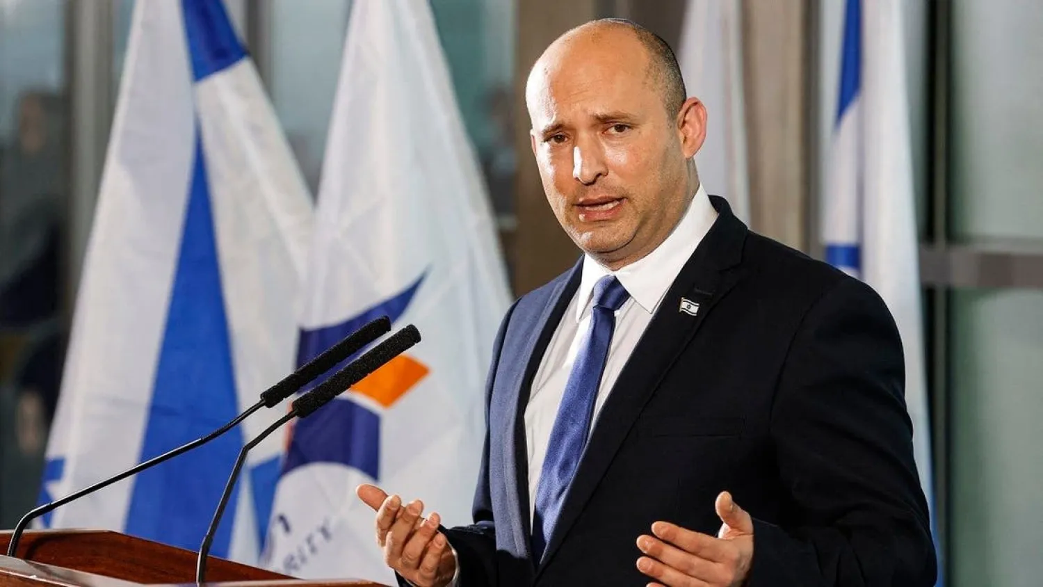 Israeli Prime Minister Naftali Bennett addresses reporters at Ben Gurion International Airport on June 22, 2021. (Jack Guez/AFP)
