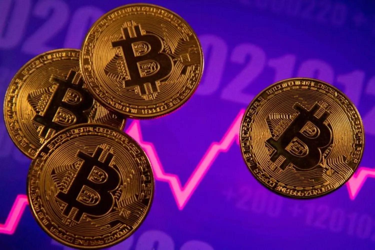 A representation of virtual currency Bitcoin is seen in front of a stock graph in this illustration taken March 15, 2021. (Reuters)
