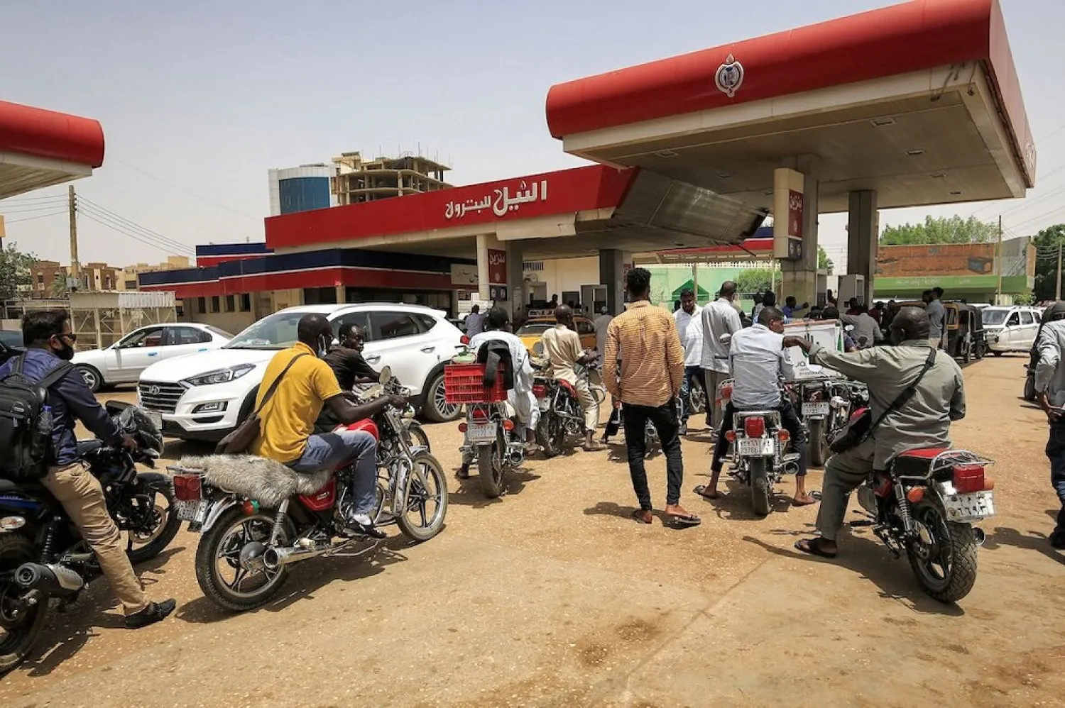 Motorcyclists queue-up for fuel at a petrol station in al-Amarat district of Sudan's capital Khartoum on June 10, 2021. (Getty Images)