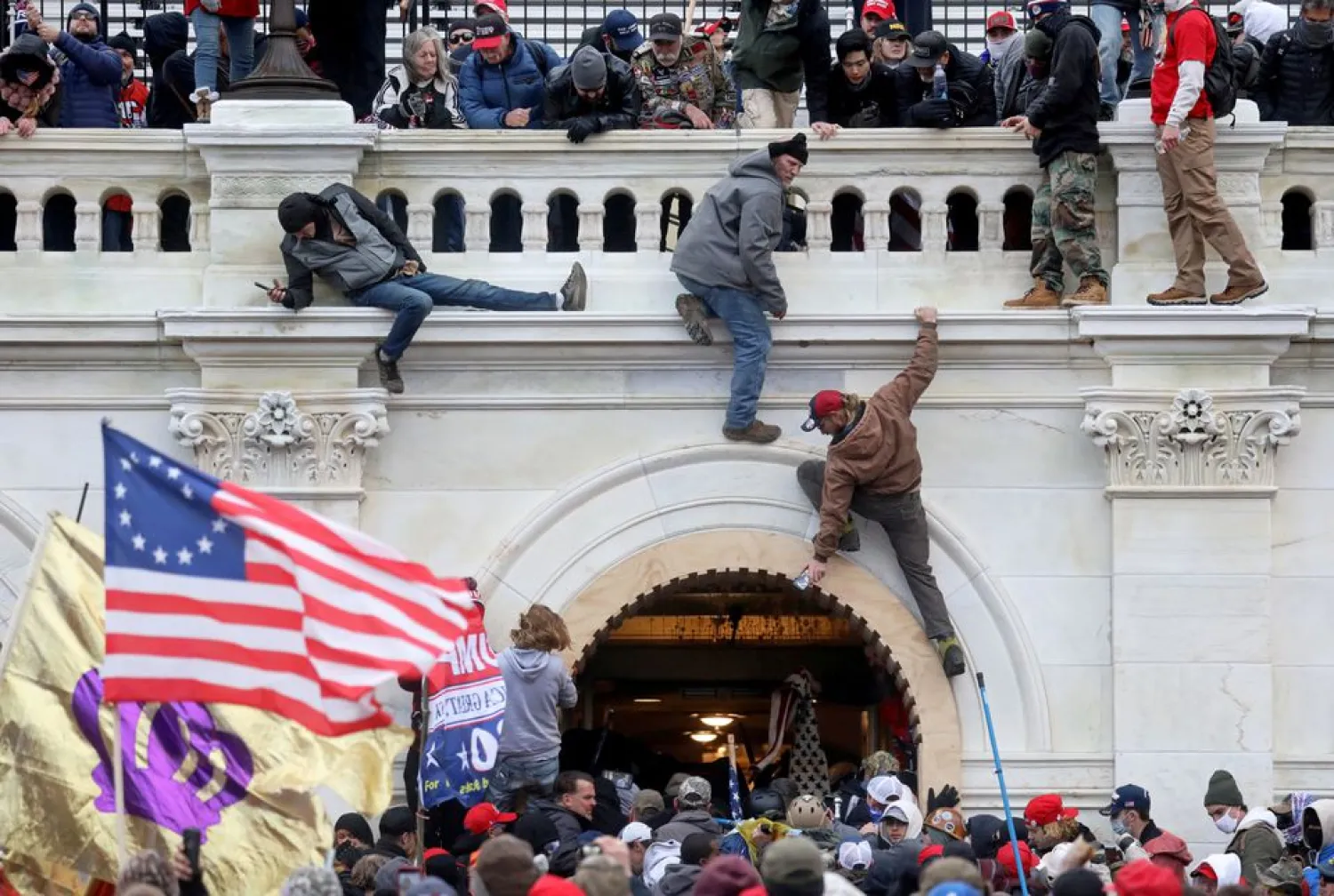 A mob of supporters of former US President Donald Trump fight with members of law enforcement at a door they broke open as they storm the US Capitol Building in Washington, US, January 6, 2021.
(photo credit: REUTERS/LEAH MILLIS/FILE PHOTO)