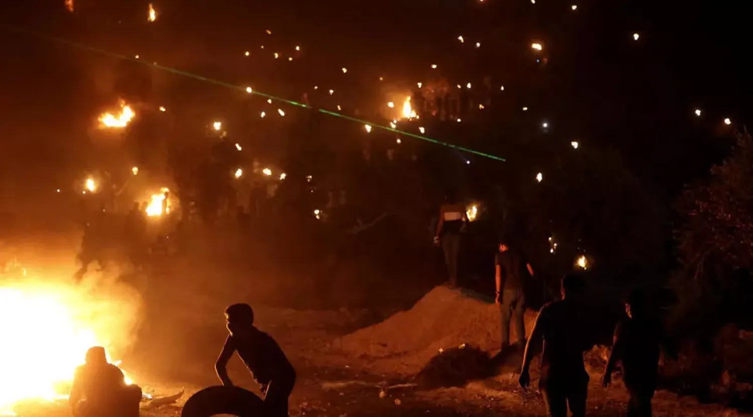 The protesting Palestinians burn tyres and the prevailing wind takes the acrid smoke towards the newly established Eviatar settlement ABBAS MOMANI AFP
