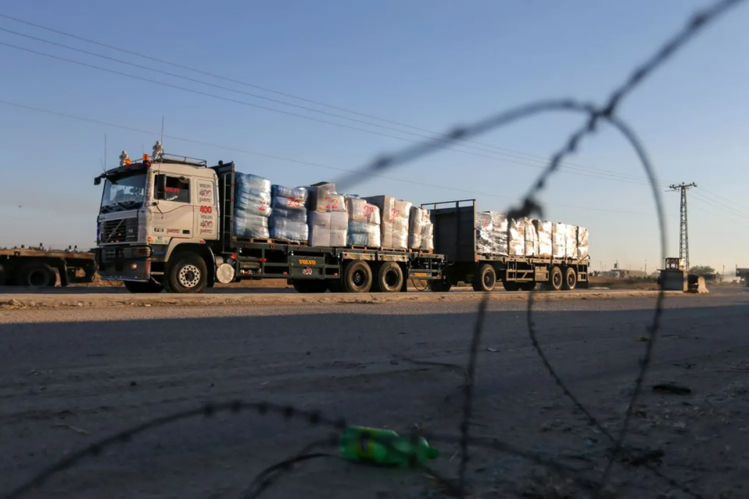 A truck carrying clothes for export is seen at Kerem Shalom crossing in Rafah in the southern Gaza Strip, June 21, 2021. REUTERS/Ibraheem Abu Mustafa/Files