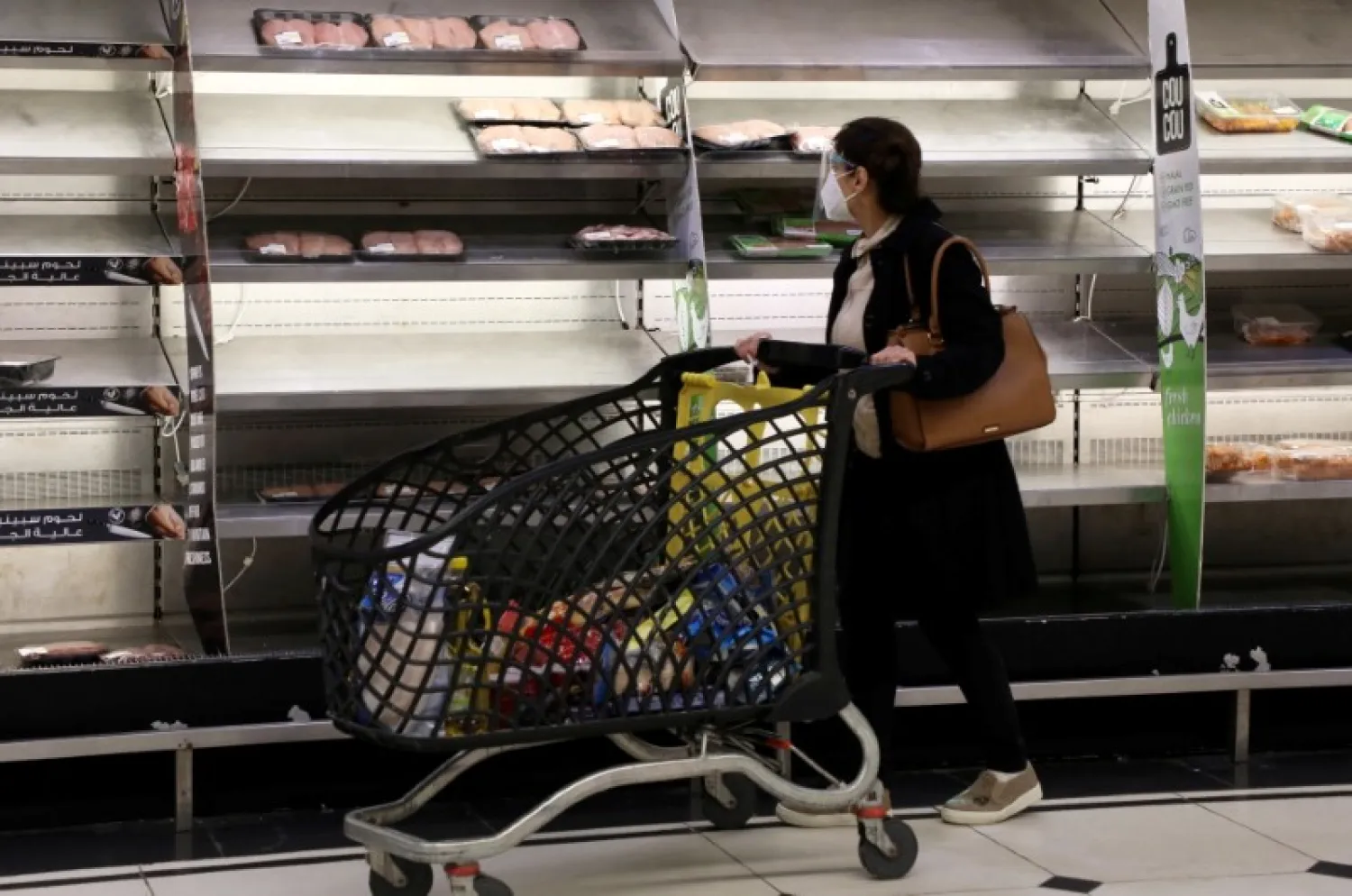 A shopper walks past near-empty shelves at a supermarket in Beirut, Lebanon March 16, 2021. REUTERS/Mohamed Azakir/File Photo

 