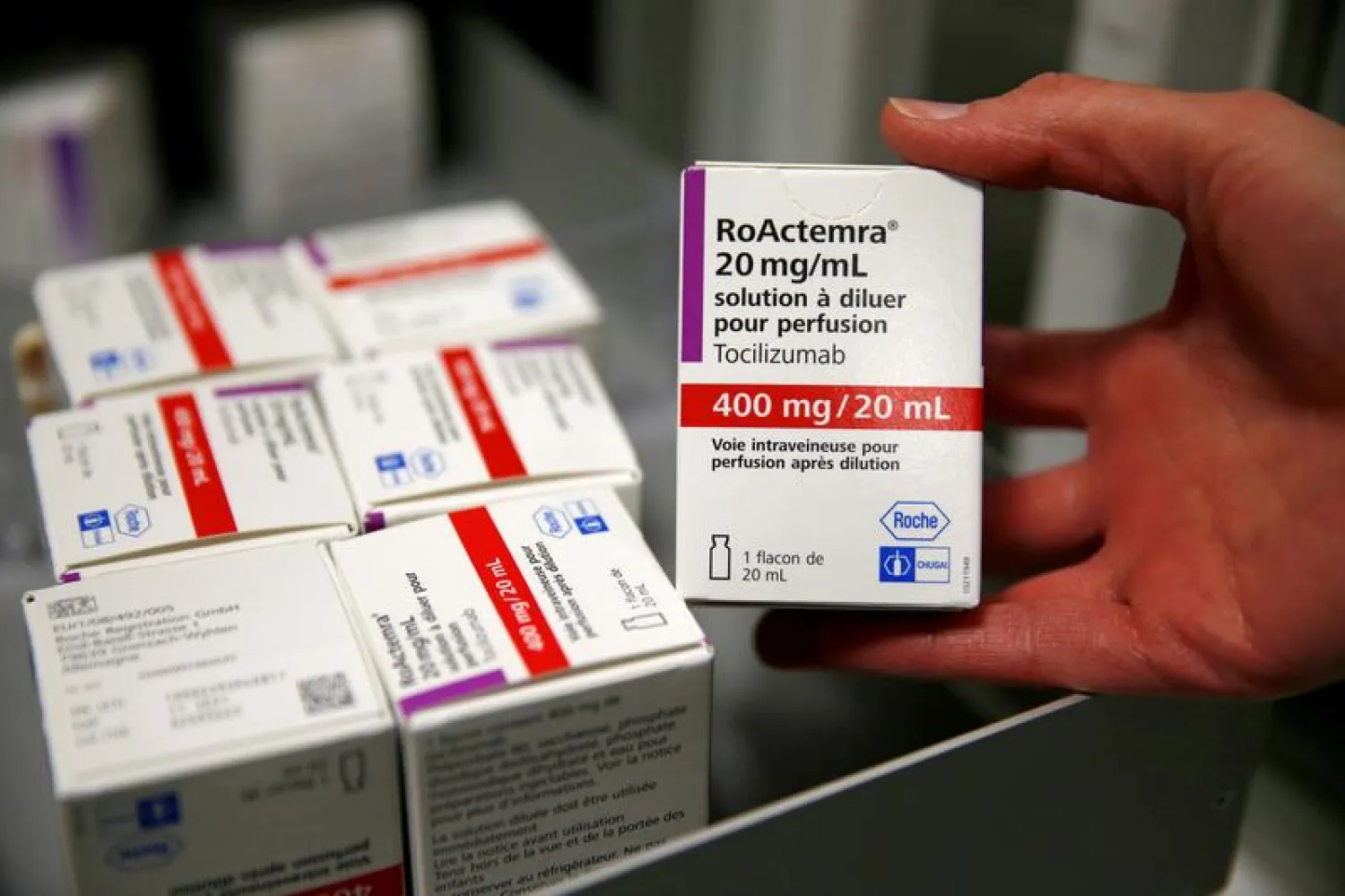 A pharmacist displays a box of tocilizumab, which is used in the treatment of rheumatoid arthritis, at the pharmacy of Cambrai hospital, France, April 28, 2020. (Reuters)