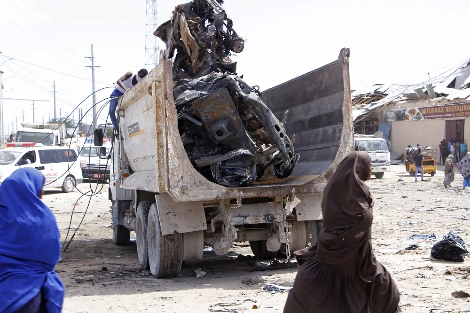 A truck carries the wreckage of a car used in a bomb attack in Mogadishu, Somalia, December 28, 2019. (AP)
