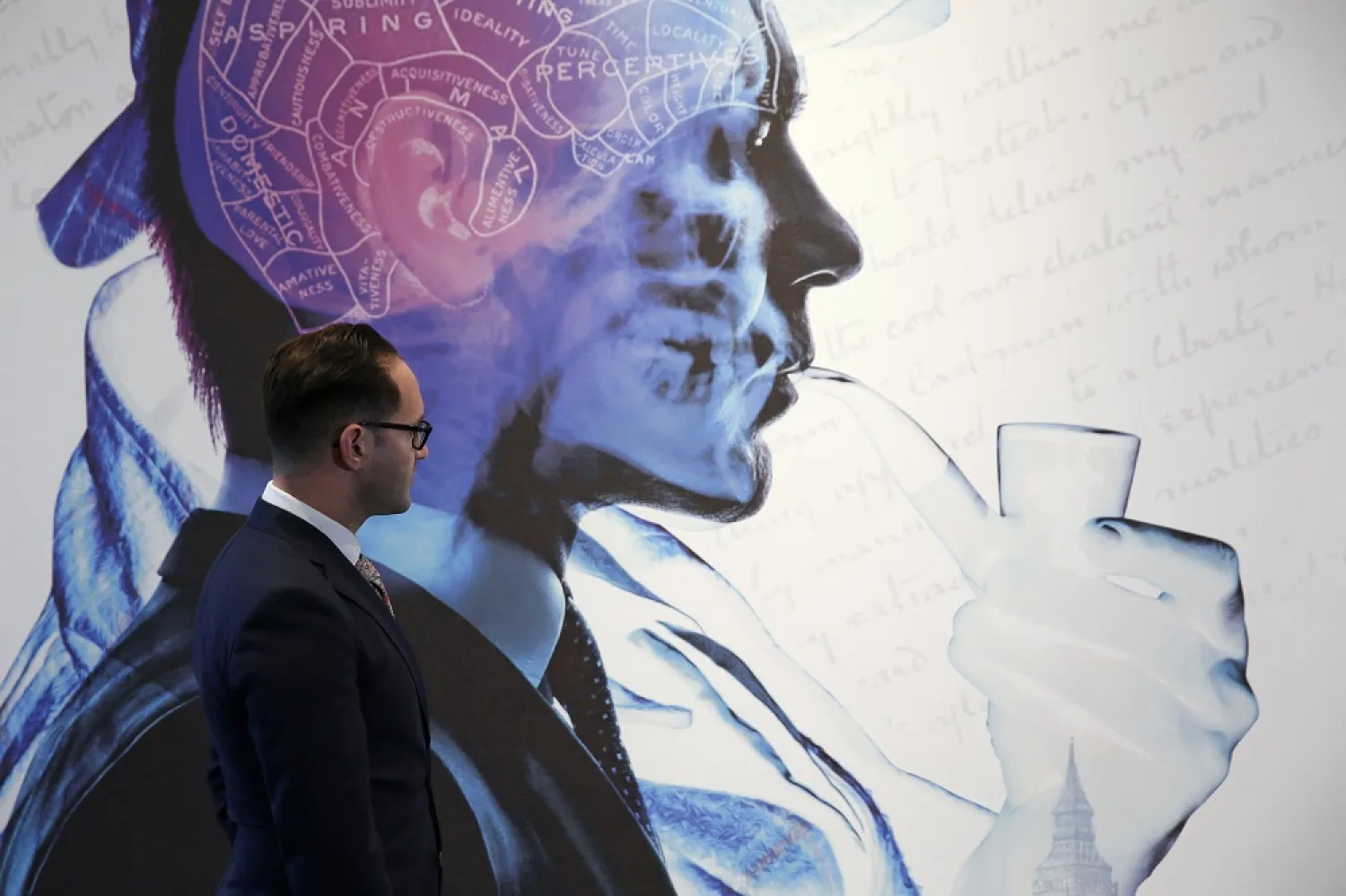 A worker looks at a “Sherlock Holmes The Man Who Never Lived and Will Never Die” exhibition poster at the Museum of London in London October 16, 2014. (Reuters)