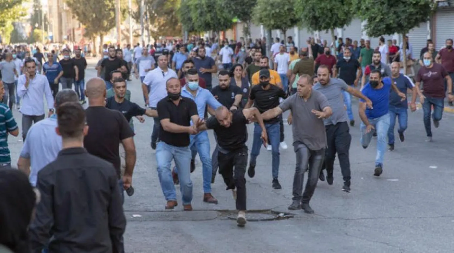 Security men in civilian clothes chasing down a protester in Ramallah on Saturday (AP)

