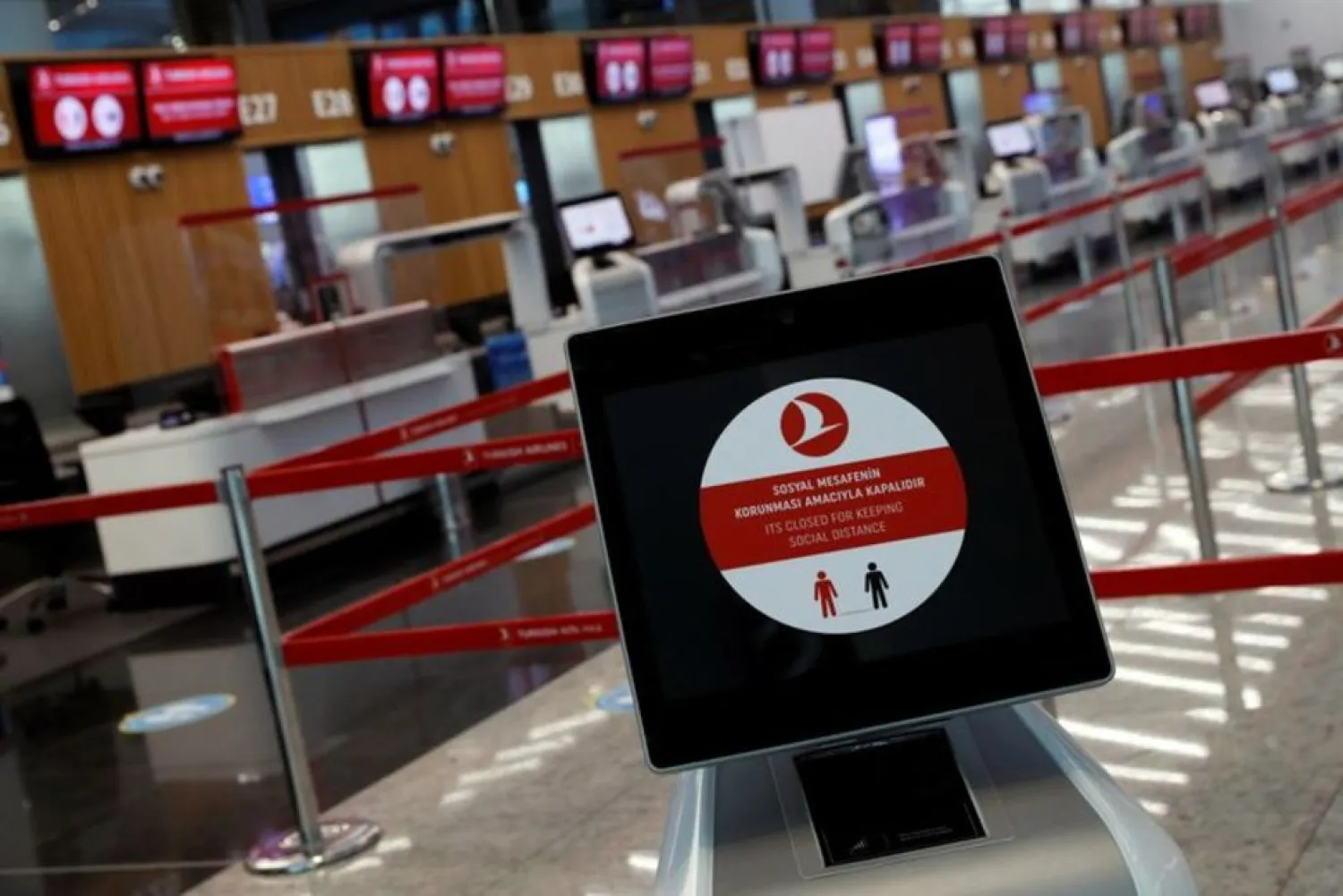 A social distancing sign is seen before the Turkish Airlines check-in counters at the international departure terminal of the Istanbul Airport amid the coronavirus disease (COVID-19) outbreak, in Istanbul, Turkey June 19, 2020. (Reuters)