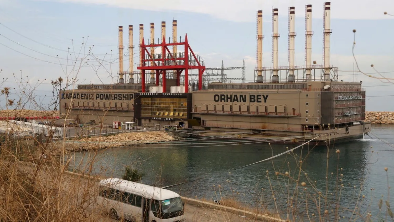 A bus drives past the Karadeniz Powership Orhan Bey, an electricity-generating ship from Turkey, docked at the port of Jiyeh, south of Beirut, Lebanon October 26, 2015. (Reuters)