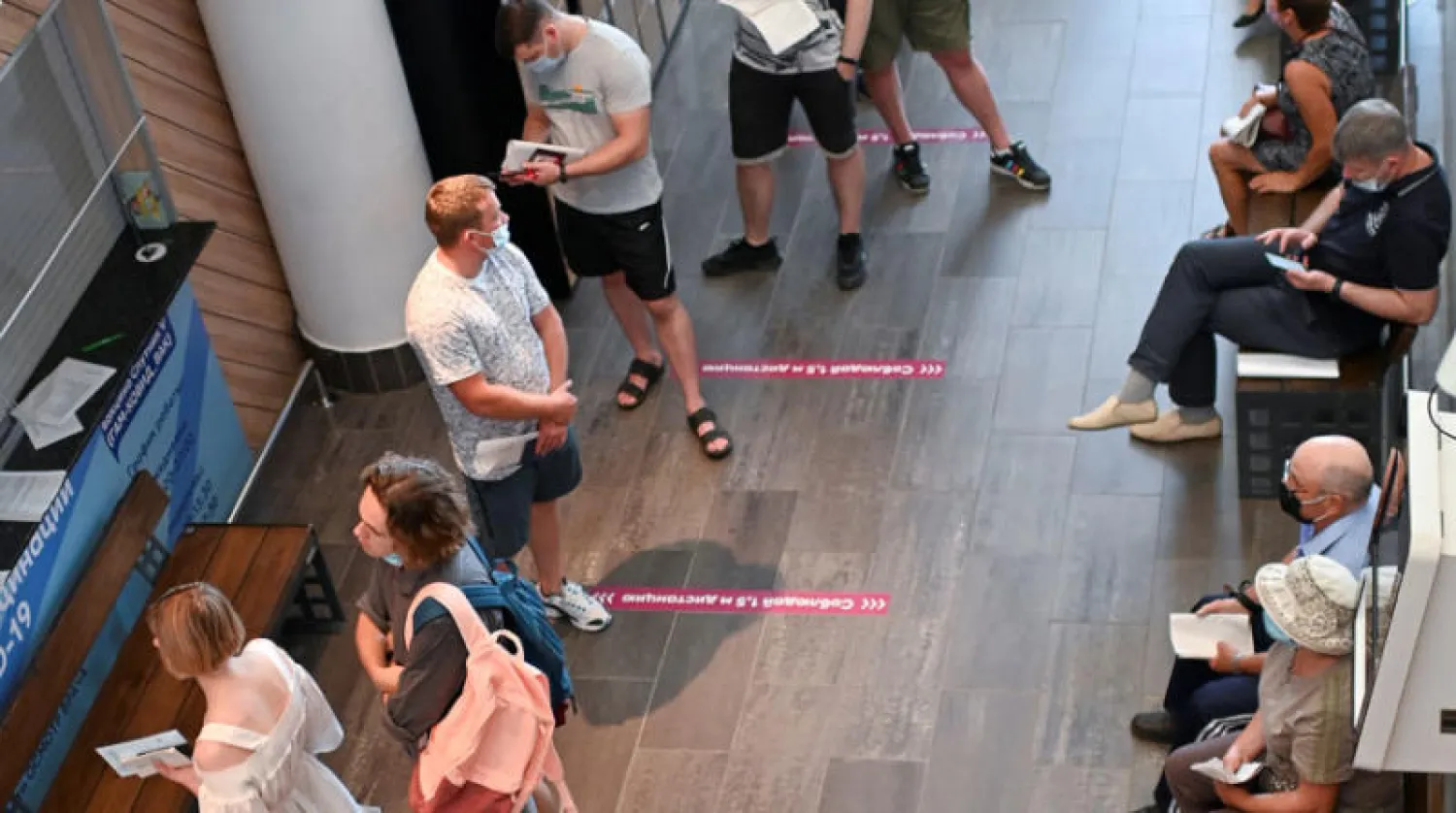 طابور في مركز للتلقيح ضد «كورونا» في أومسك الروسية أمس (رويترز)