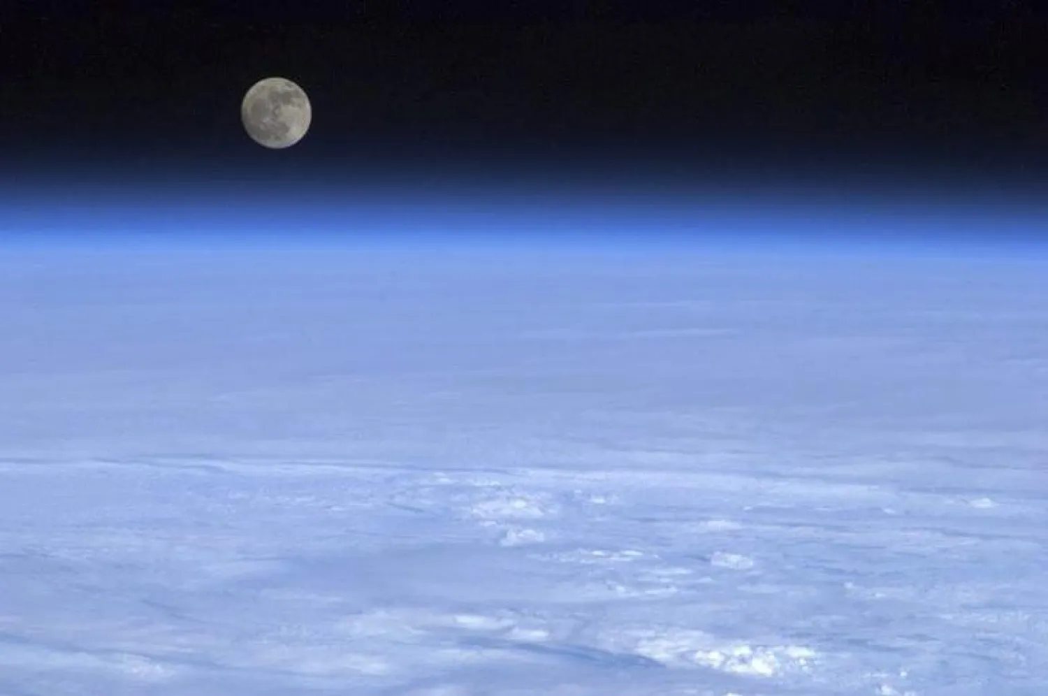 The moon is pictured above Earth in this handout photo courtesy of Col. Chris Hadfield of the Canadian Space Agency. REUTERS/CSA/Col. Chris Hadfield/Handout