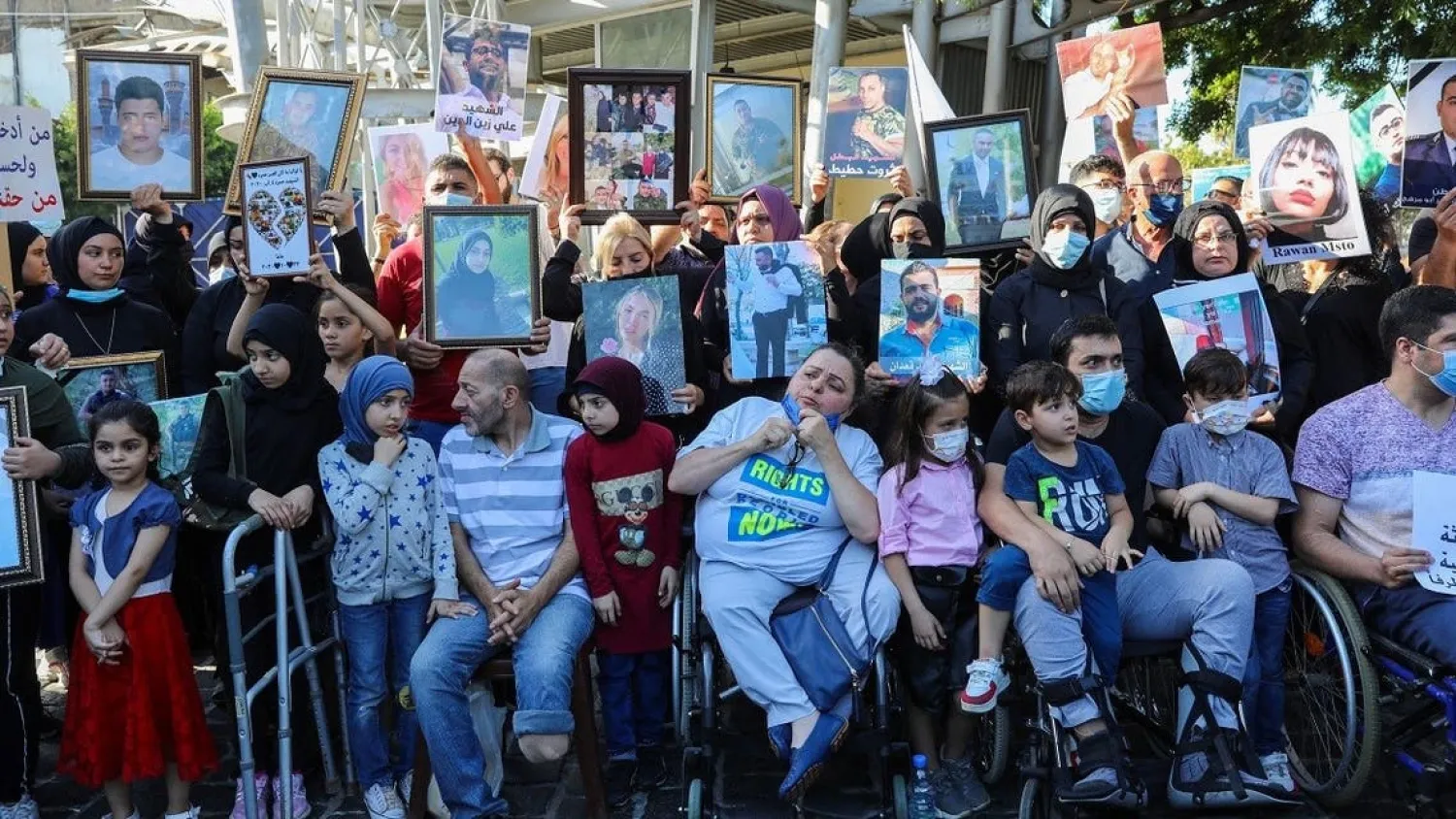 Relatives of victims of Beirut’s port blast hold their pictures as they rally in the Lebanese capital on July 4, 2021. (Anwar Amro/AFP)
