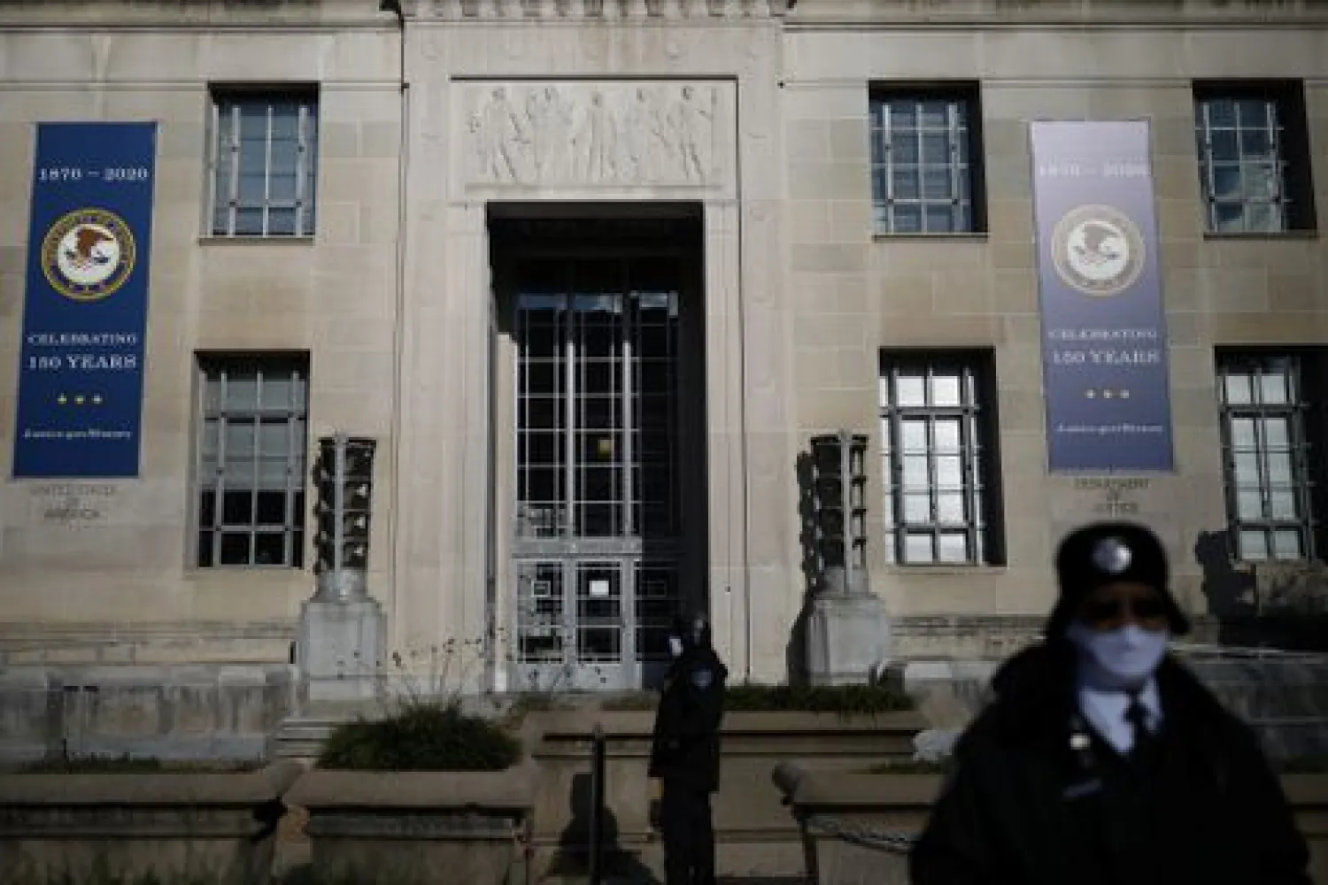 Security officers stand guard outside the US Department of Justice Building in Washington, US, December 2, 2020. REUTERS/Tom Brenner

