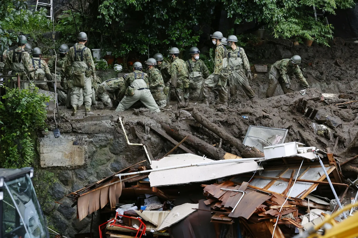 Members of Japanese Self-Defense Forces conduct rescue and search operation at a mudslide site caused by heavy rain at Izusan district in Atami, west of Tokyo, Japan July 5, 2021, in this photo taken by Kyodo. Kyodo/via REUTERS