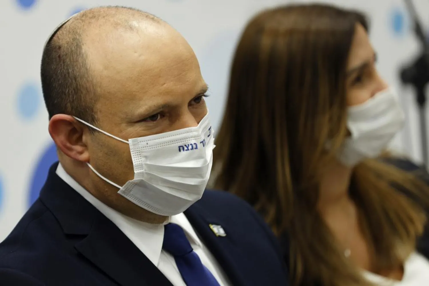 Israeli Prime Minister Naftali Bennett, left, looks on during his visit to a Maccabi healthcare maintenance organisation (HMO) outlet which offers vaccinations against the coronavirus disease (COVID-19) in Holon, near Tel Aviv, Israel Tuesday, June 29, 2021. (Amir Cohen/Pool Photo via AP)
