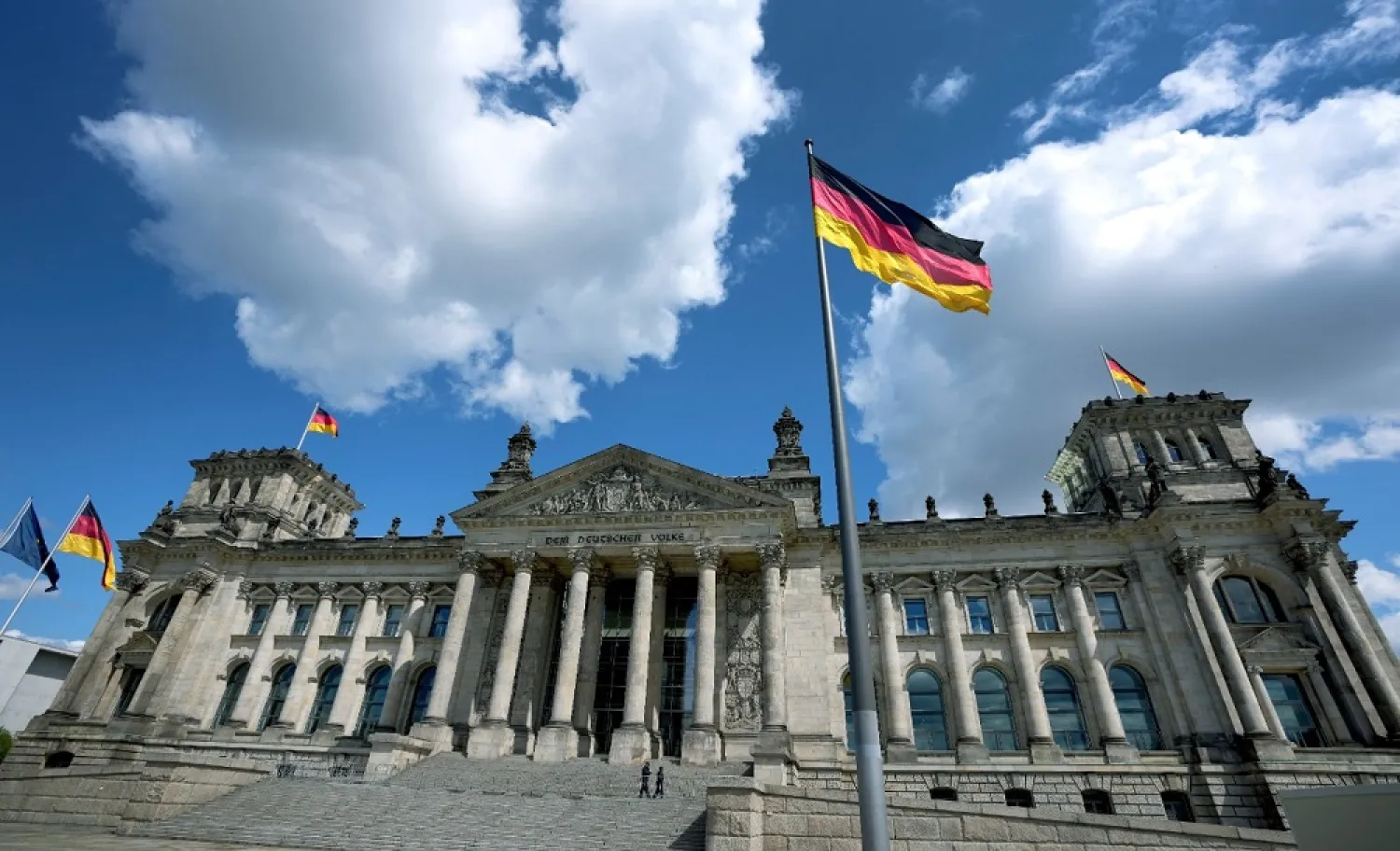 A German national flag waves in front of the German federal parliament, Bundestag, at the Reichstag building in Berlin, Germany, Wednesday, May 19, 2021. (AP)