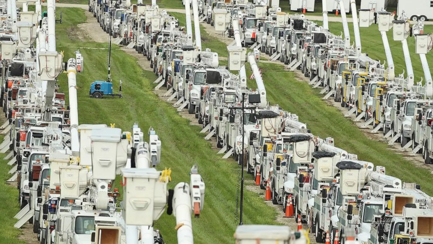 About 250 electrical utility trucks are lined up at Duke Energy's staging location in The Villages of Sumter County on Tuesday, July 6, 2021. (Stephen M. Dowell/Orlando Sentinel via AP)
