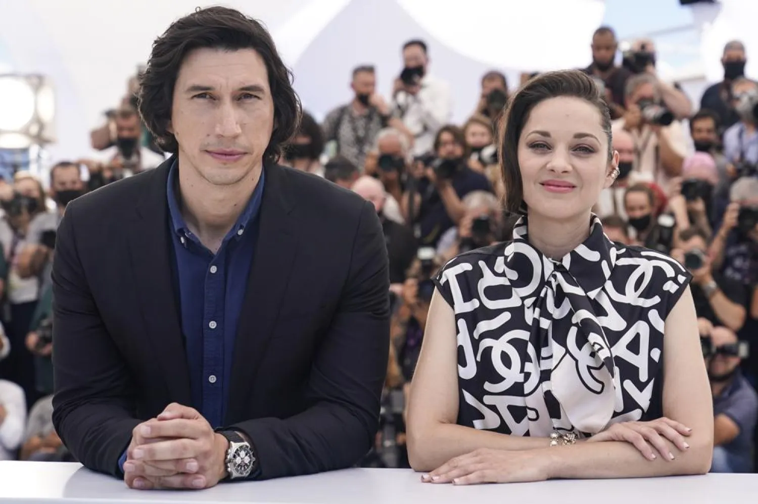 Adam Driver, left, and Marion Cotillard pose for photographers at the photo call for the film Annette at the 74th international film festival, Cannes, southern France, Tuesday, July 6, 2021. (AP)