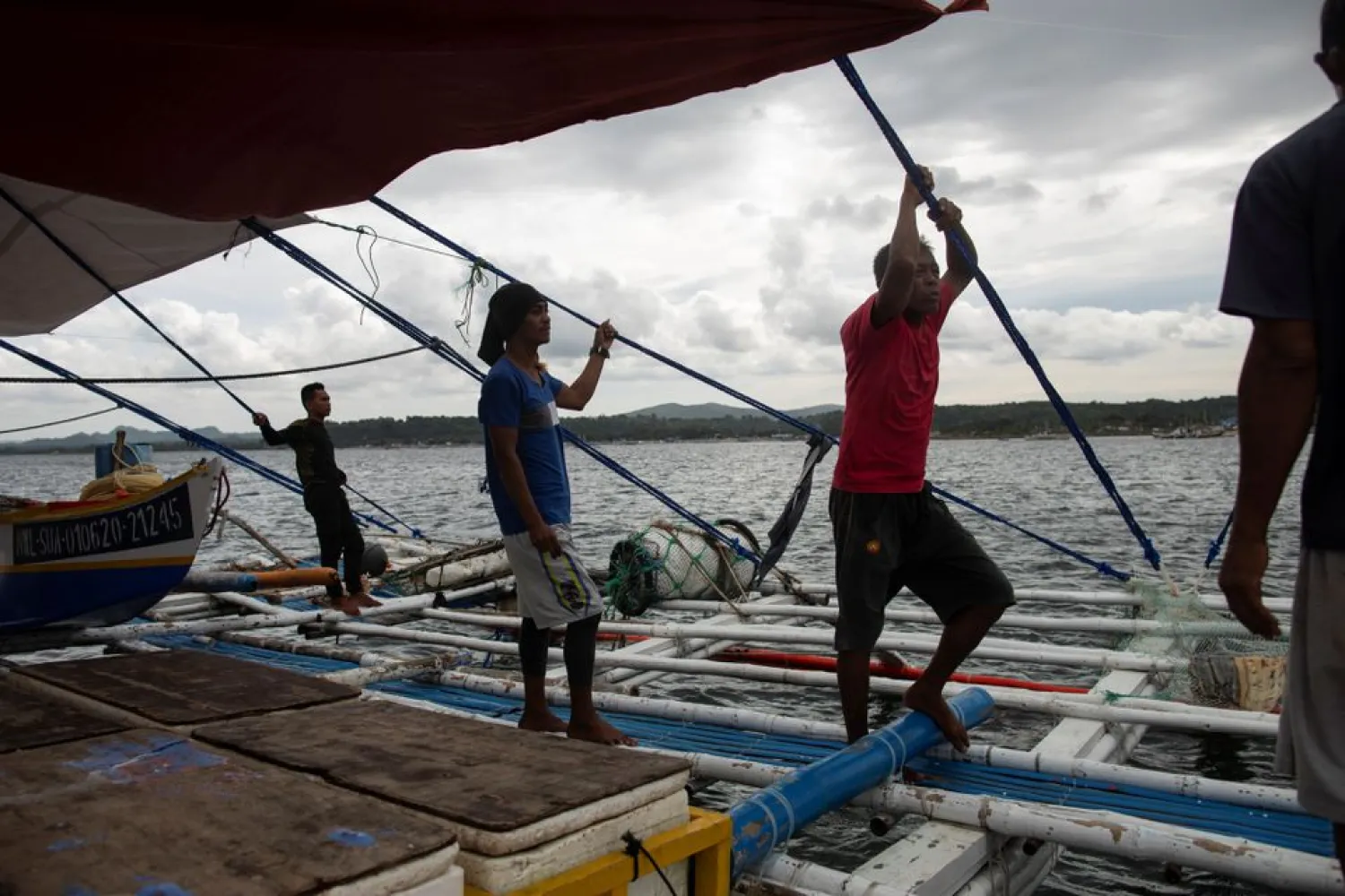 Filipino fishermen rest after arriving from a week-long trip to the disputed Scarborough Shoal, in Infanta, Pangasinan province, Philippines, July 6, 2021. (Reuters)