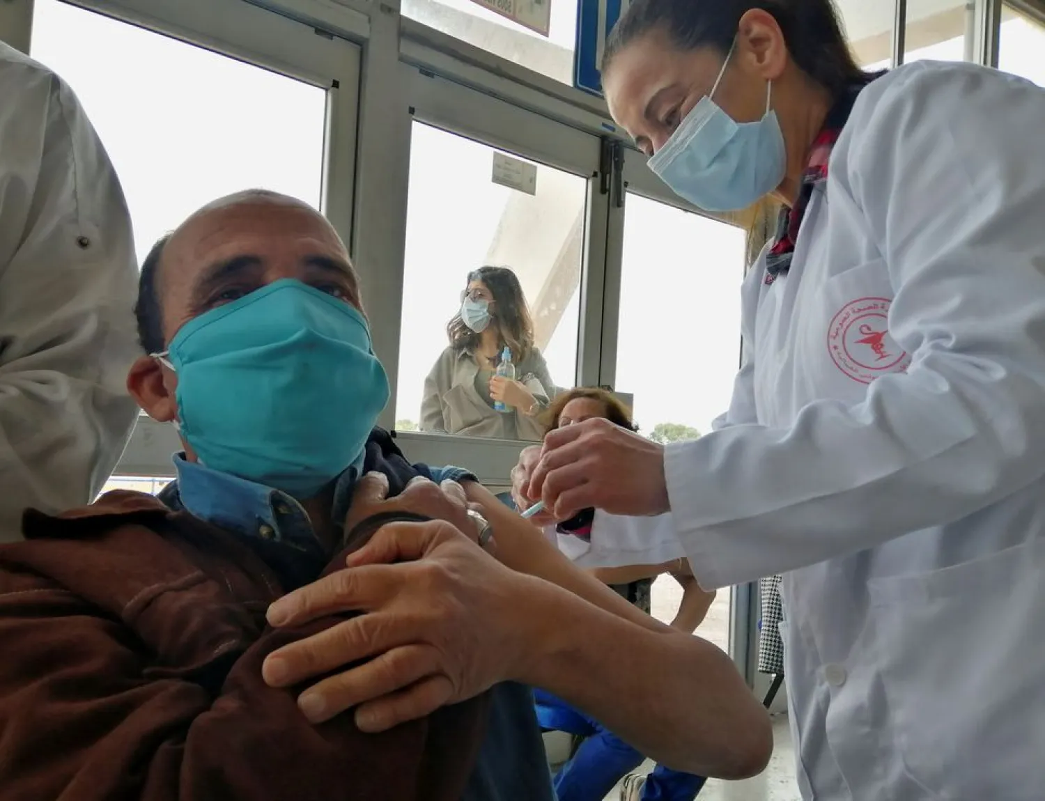 A man receives a coronavirus disease (COVID-19) vaccine at a vaccination centre in Tunis, Tunisia, April 26, 2021. Picture taken April 26, 2021. REUTERS/Jihed Abidellaoui