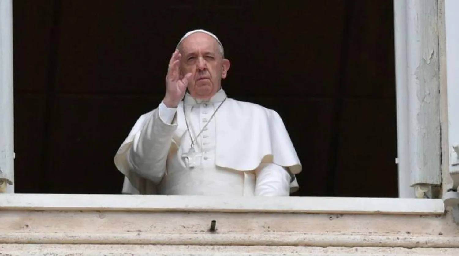Pope Francis waves from the window of the Apostolic Palace on Easter Monday at the Vatican April 13, 2020. Vatican Media/­Handout via REUTERS