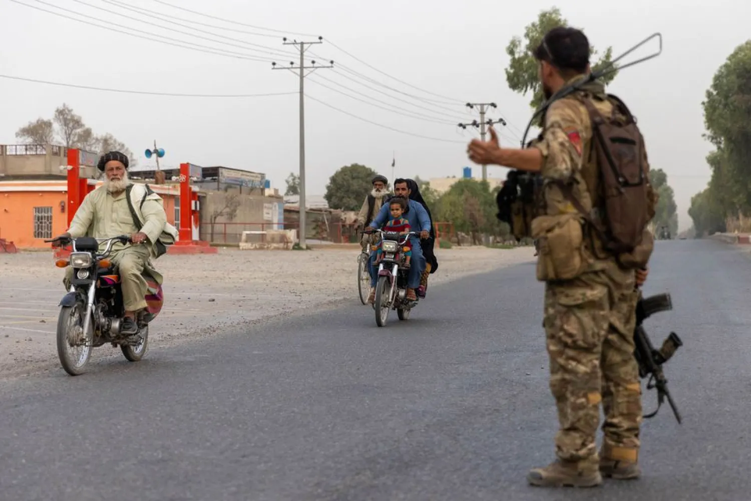 A member of the Afghan Special Forces directs traffic during the rescue mission of a policeman besieged at a check post surrounded by Taliban, in Kandahar province, Afghanistan, July 13, 2021. (Reuters)