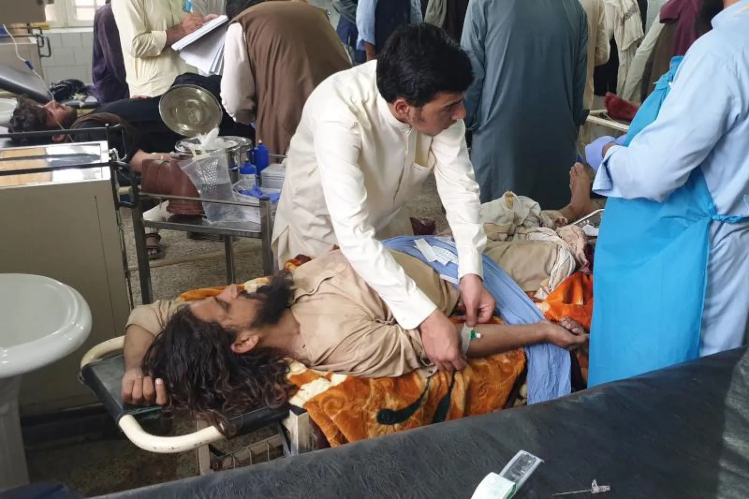 رجال الإسعاف يعالجون مصاباً جراء الاشتباكات بين القوات الأفغانية و«طالبان» (أ.ف.ب)