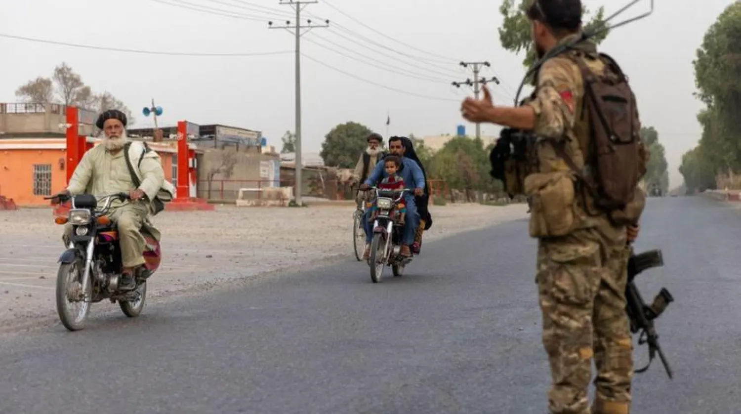 A member of the Afghan Special Forces directs traffic during the rescue mission of a policeman besieged at a check post surrounded by Taliban, in Kandahar province, Afghanistan, July 13, 2021. (Reuters)