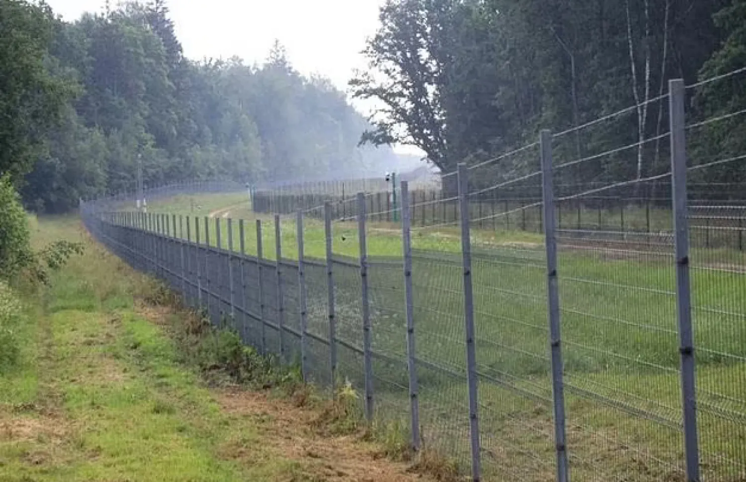 The border line in Medininkai, Lithuania, separating Lithuania (L) and Belarus - 

