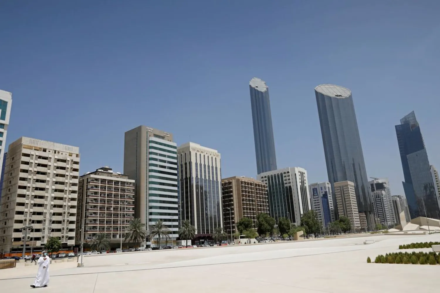 An Emirati man wears a protective mask as he walks past buildings in Abu Dhabi, United Arab Emirates September 1, 2020. REUTERS/Nir Elias/Pool/File Photo