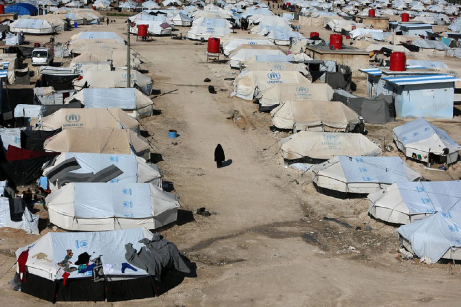 A woman walks through Al-Hol displacement camp in Hasaka governorate, Syria. Reuters file photo