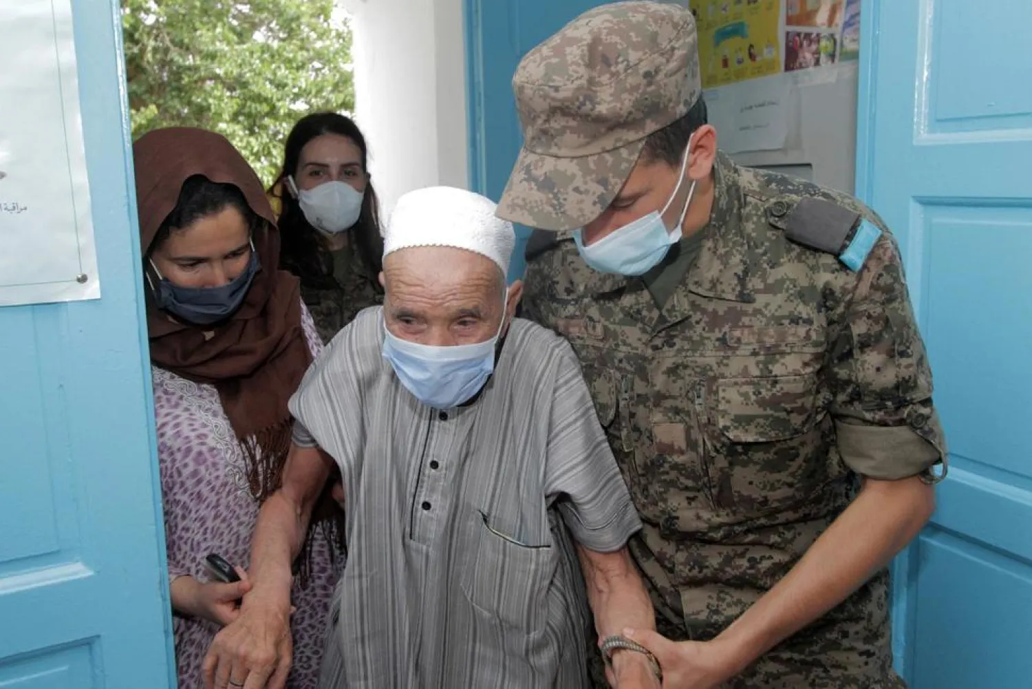 A soldier helps and elderly man to enter the vaccination center in Kesra,130 kilometers (80 miles) south of Tunis, Tuesday, July 13, 2021.(AP Photo/Saber Zidi) THE ASSOCIATED PRESS


