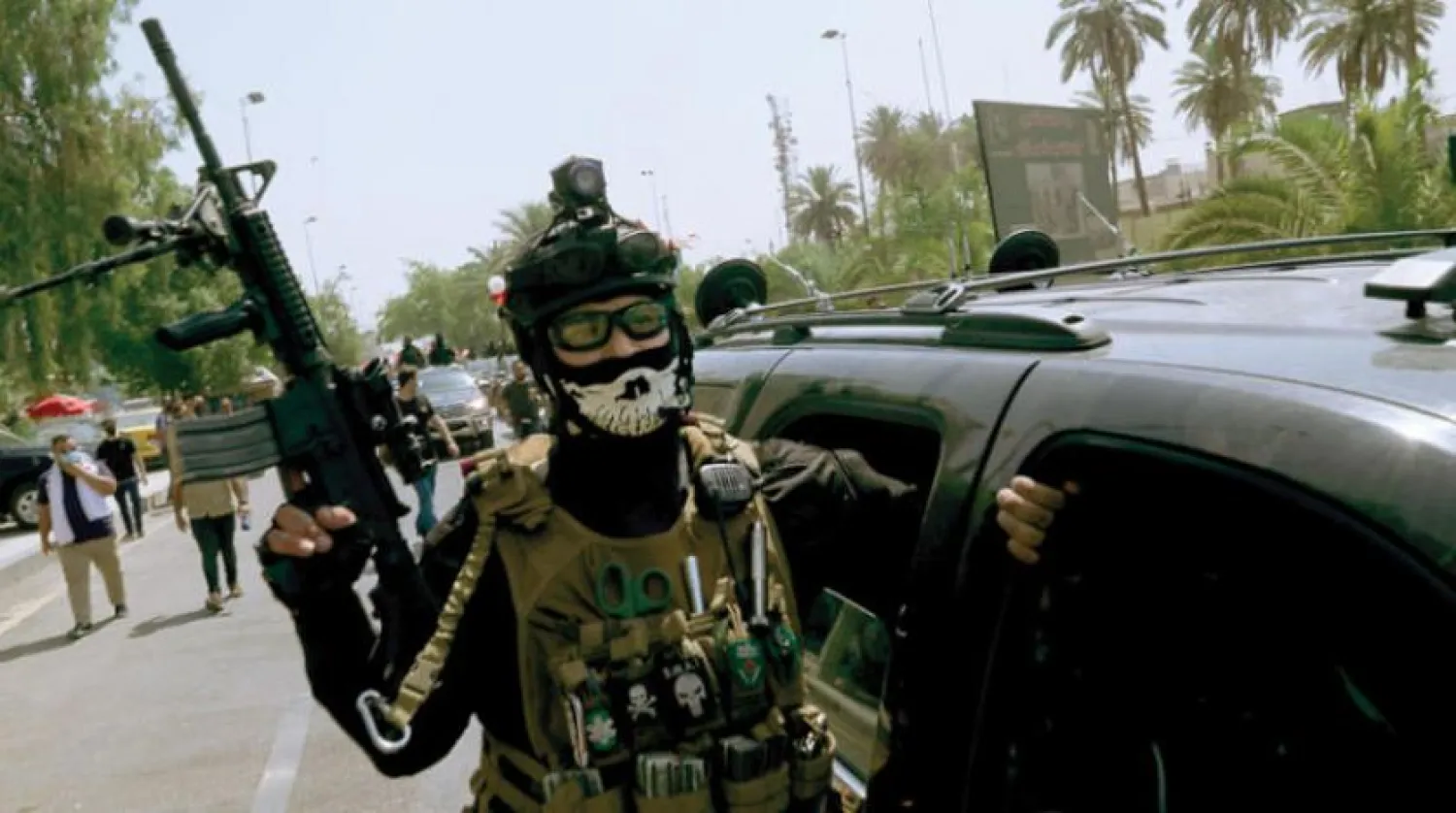  Iranian-backed Iraqi militia members roam the streets of Baghdad on June 29 (AP)