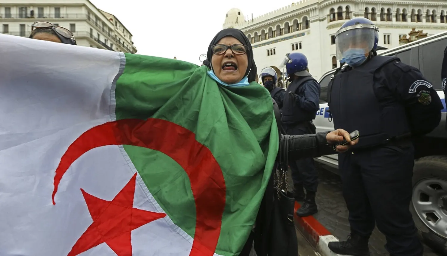 A woman holds an Algerian flag during a protest. (AP file photo)