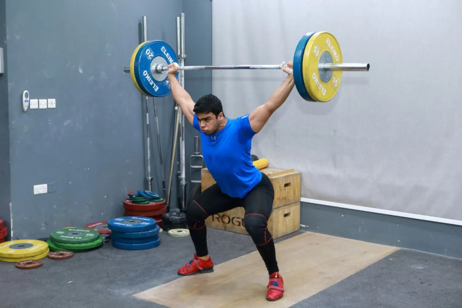Gaza weight-lifter Mohammad Hamada who is the first Palestinian to compete in the game at the Olympics when it kicks off in Tokyo, practices at a gym in Doha, Qatar July 18, 2021. (Reuters)