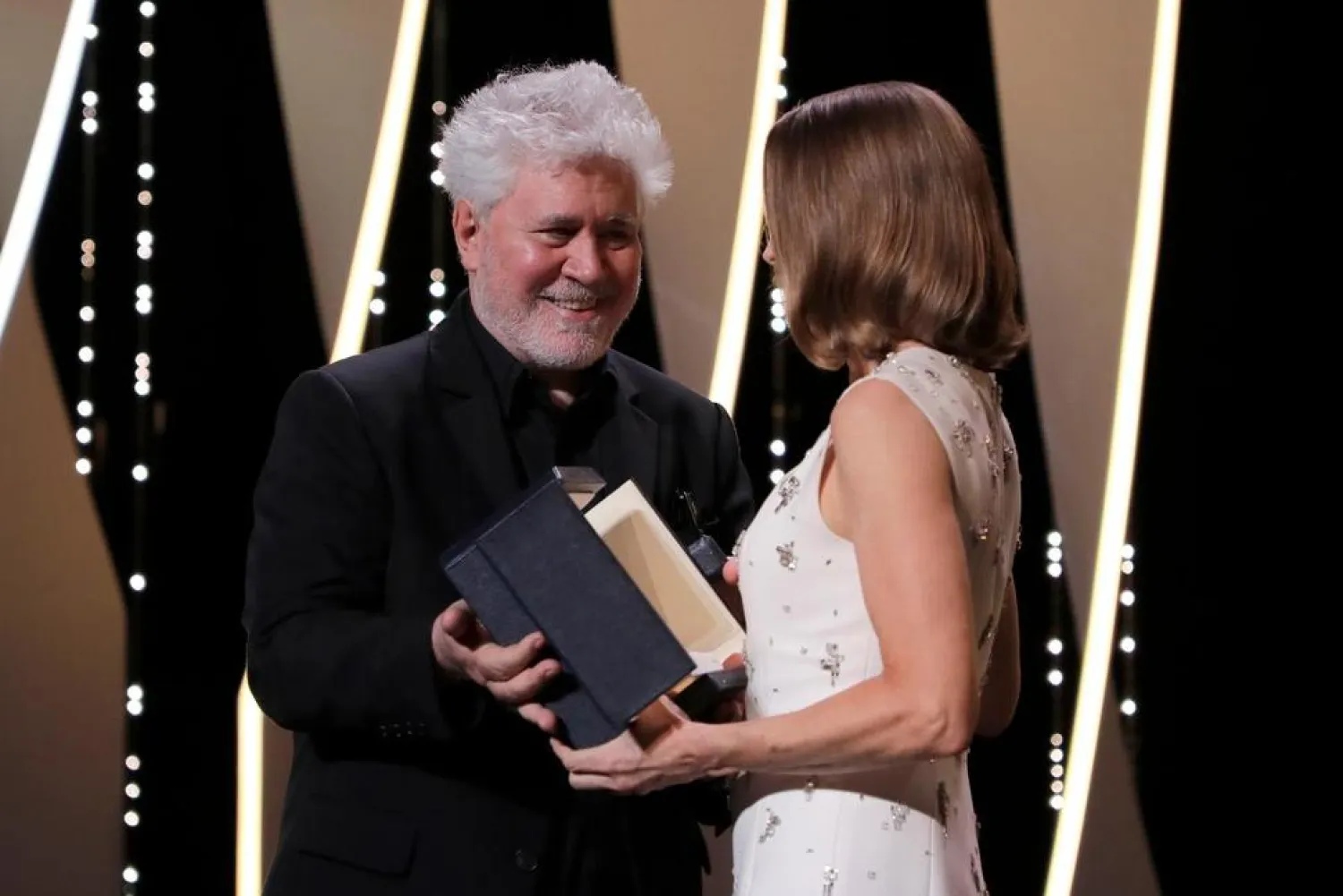 Pedro Almodóvar, left, presents Jodi Foster with an honorary Palme d’Or at the opening ceremony of the 74th international film festival, Cannes, southern France, Tuesday, July 6, 2021. (AP)