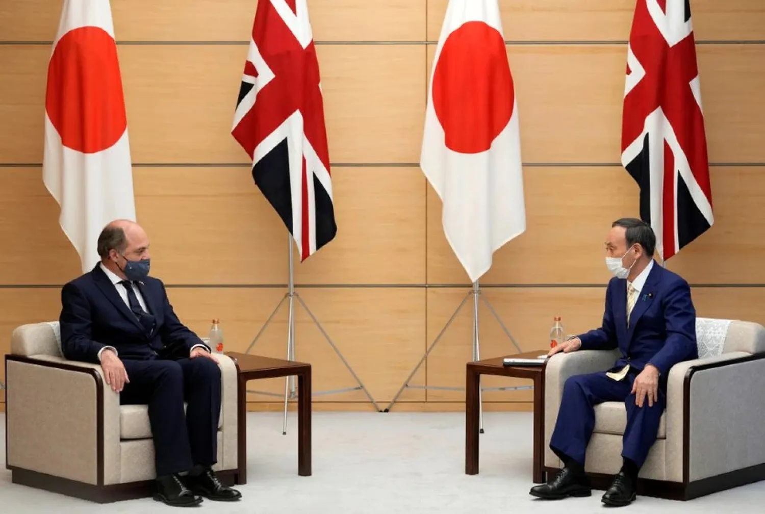 Britain’s Defense Secretary Ben Wallace listens to Japan’s Prime Minister Yoshihide Suga at the start of their meeting at the prime minister’s official residence in Tokyo, Japan, July 20, 2021. (Reuters)